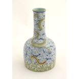 A Chinese famille rose mallet shaped vase with enamel decoration depicting dragons emerging out of