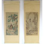 Two Oriental scrolls with woodblock decoration, one depicting 2 figures and a snake,