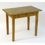 A late 19thC chestnut side table / writing table with a three plank top above a single frieze