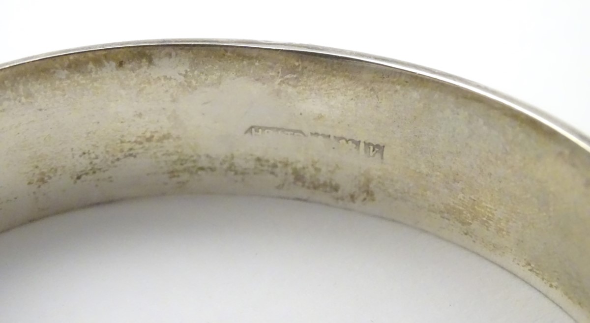 A hallmarked silver bangle formed ' Excalibur' bracelet with engraved decoration. - Image 5 of 5
