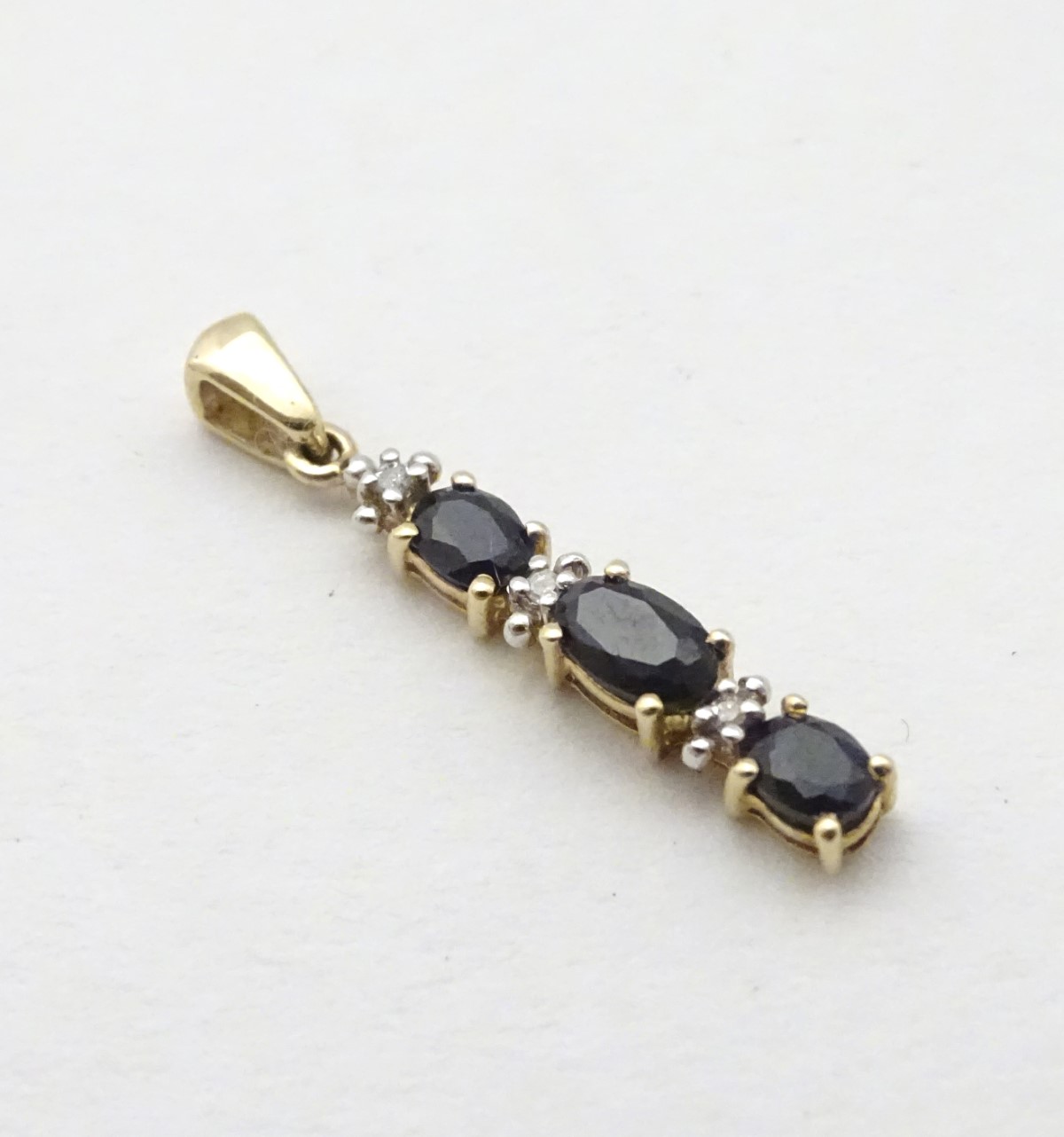 A 9ct gold pendant set with spinels and diamonds, 1” long. - Image 4 of 6