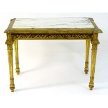 A mid 19thC marble topped centre table with a gilt wood base having a carved frieze with floral