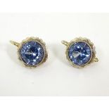 A pair of 9ct gold earrings set with facet cut aquamarines,