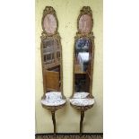 A pair of 19thC gilt wood console tales with marble tops below mirrors with carved frames and