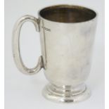 A silver mug with loop handles hallmarked Sheffield 1954 maker Walker & hall.