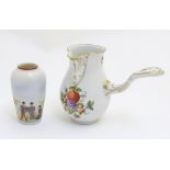 A pouring jug decorated with fruits, nuts and vines with gilt highlights made by Herend,