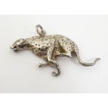 A silver pendant formed as a running cheetah,