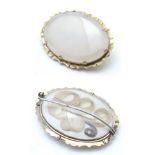 A 19thC oval brooch set with chalcedony cabochon to one side and memorial / mourning lock of hair