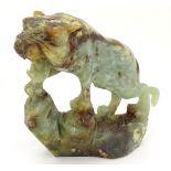 A Chinese jade / hardstone sculpture carved as a prowling tiger. Approx. 7 1/2" high x 8" long.