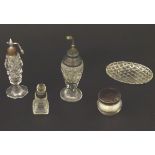 Assorted cut glass scent bottles, together with a glass pot and pin dish, some with silver mounts.