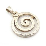 A silver pendant of spiral form with hammered decoration.