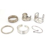 6 assorted silver and white metal bracelets many of bangle form.