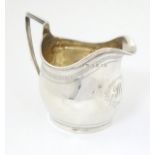 A silver cream jug hallmarked London 1809 maker TH.