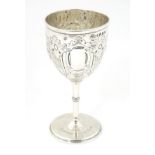 A Victorian silver cup with embossed decoration and engraved 'Rushcliff Gold Club 1938'