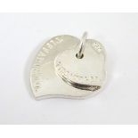 A Silver pendant of stylised heart shape marked 'Tiffany & Co' CONDITION: Please
