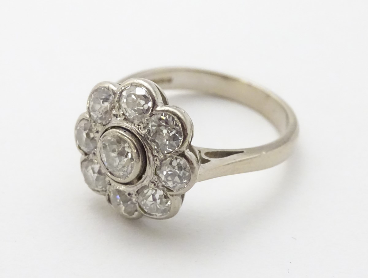 An 18ct white gold ring set with central old cut diamond bordered by 8 further diamonds in a daisy - Image 4 of 8