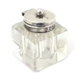 A glass inkwell of squared form with silver top hallmarked Sheffield 1897 maker W W Harrison & Co 1