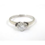 A white gold ring set with central diamond solitaire. Approx. 0.