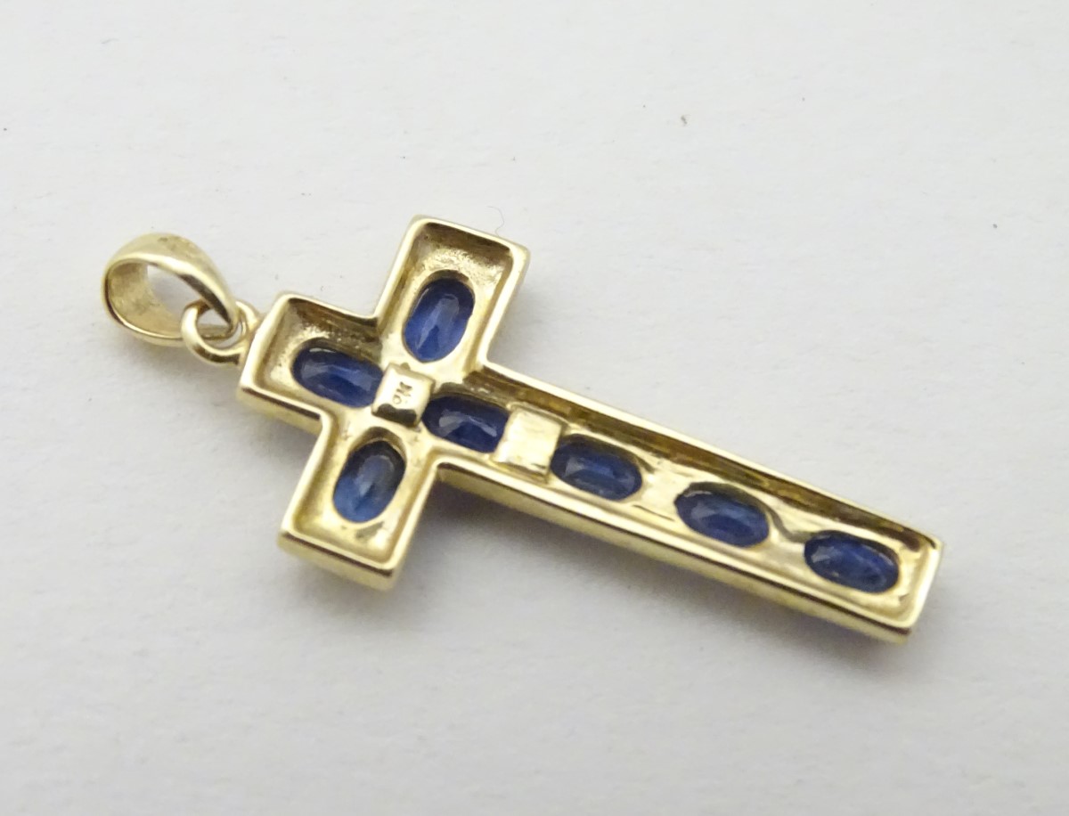 A 9ct gold cross formed pendant set with 7 topaz. - Image 2 of 4