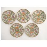 Five Cantonese plates with panelled decoration depicting figures in interior settings and birds