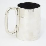 A silver mug with loop handle hallmarked Chester 1912 maker Haseler Borthers.