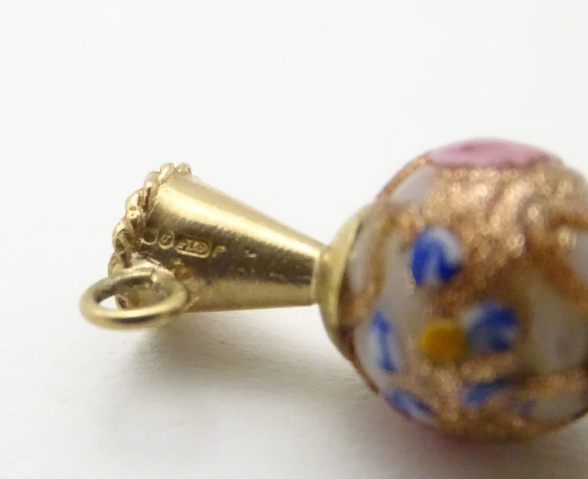 A 9ct gold charm formed as a ewer with a Venetian bead formed body. - Image 2 of 7