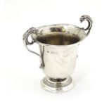 A silver twin handled trophy cup hallmarked London 1926 maker Robert Pringle & Son. 3" high.