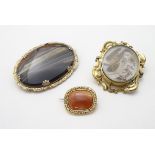 Three 19thC yellow metal brooches comprising one set with carnelian hardstone,