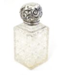 A cut glass scent bottle with silver top Approx 4 1/2" high CONDITION: Please Note
