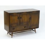 Vintage Retro: A dark elm Ercol sideboard with two cupboard doors above a single long drawer