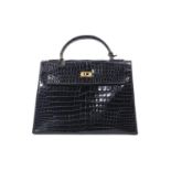 Hermès Paris, sac à main "Kelly" Sellier en crocodile noir verni, une anse et [...]