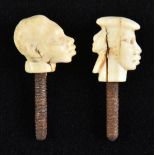 *Finials. A pair of 19th century African ivory finials, probably cane tops, carved as a male and