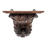 *Clock Bracket. A 19th century Continental carved wood clock bracket, the rectangular top above a