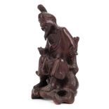 *Japanese Figure. An early 20th century Japanese carved wood figure of an elderly man sitting with a