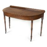 *Side Table. Victorian mahogany demi lune side table, with turned supports on brass casters, 77cm