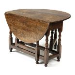 *Table. A Victorian oak gateleg table, the drop flaps with baluster supports united by stretchers,