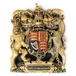 *Royal Coat of Arms. An Elizabeth II carved wood and polychrome coat of arms, laid on a black