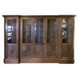 *Arts & Crafts Bookcase. A large oak glazed bookcase, circa 1910, the inverted breakfront frieze