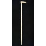 *Walking Stick. A 19th century Anglo-Indian ivory walking stick, the handles carved as a lion and
