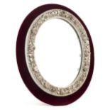 *Mirror. A Victorian floral encrusted porcelain mirror, probably Derby, of oval form finely
