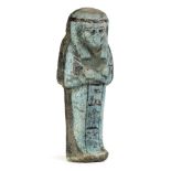 *Ancient Egypt. 22nd Dynasty, pale blue faience Shabti with detail added in black, tripartite wig