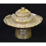 *Tibetan Silver. A 19th century Tibetan silver gilt pedestal ritual bowl and cover, profusely