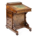*Davenport. A Victorian walnut davenport, with hinged fall with traces of tooled leather inset,