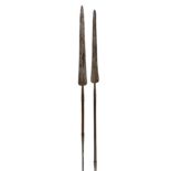 * Masai Spears. Two Masai tribe spears each with long spearhead on wooden haft, with lower spike ...
