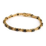 * Bracelet. A 9ct gold ladies bracelet set with 15 sapphires and 30 diamond chippings