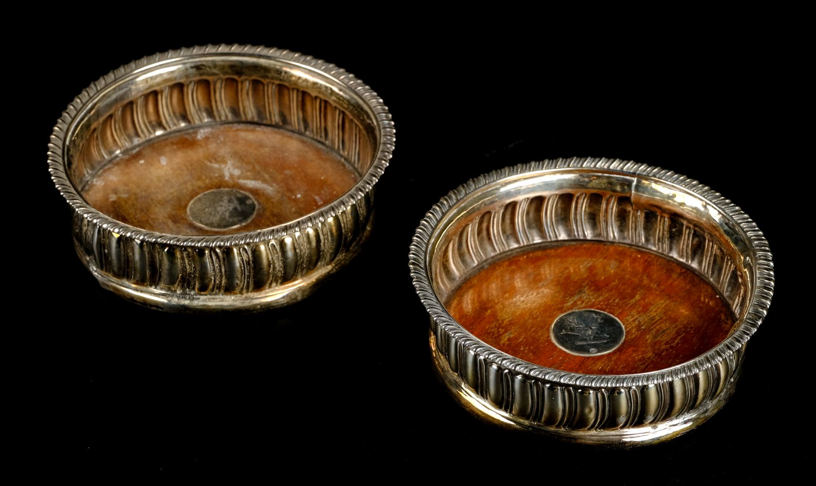 * Coasters. A pair of Georgian silver wine bottle coasters by Thomas Newby, London 1816