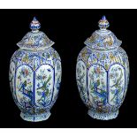 * Delft. A pair of late 19th century Dutch Delft octagonal pottery vase and covers