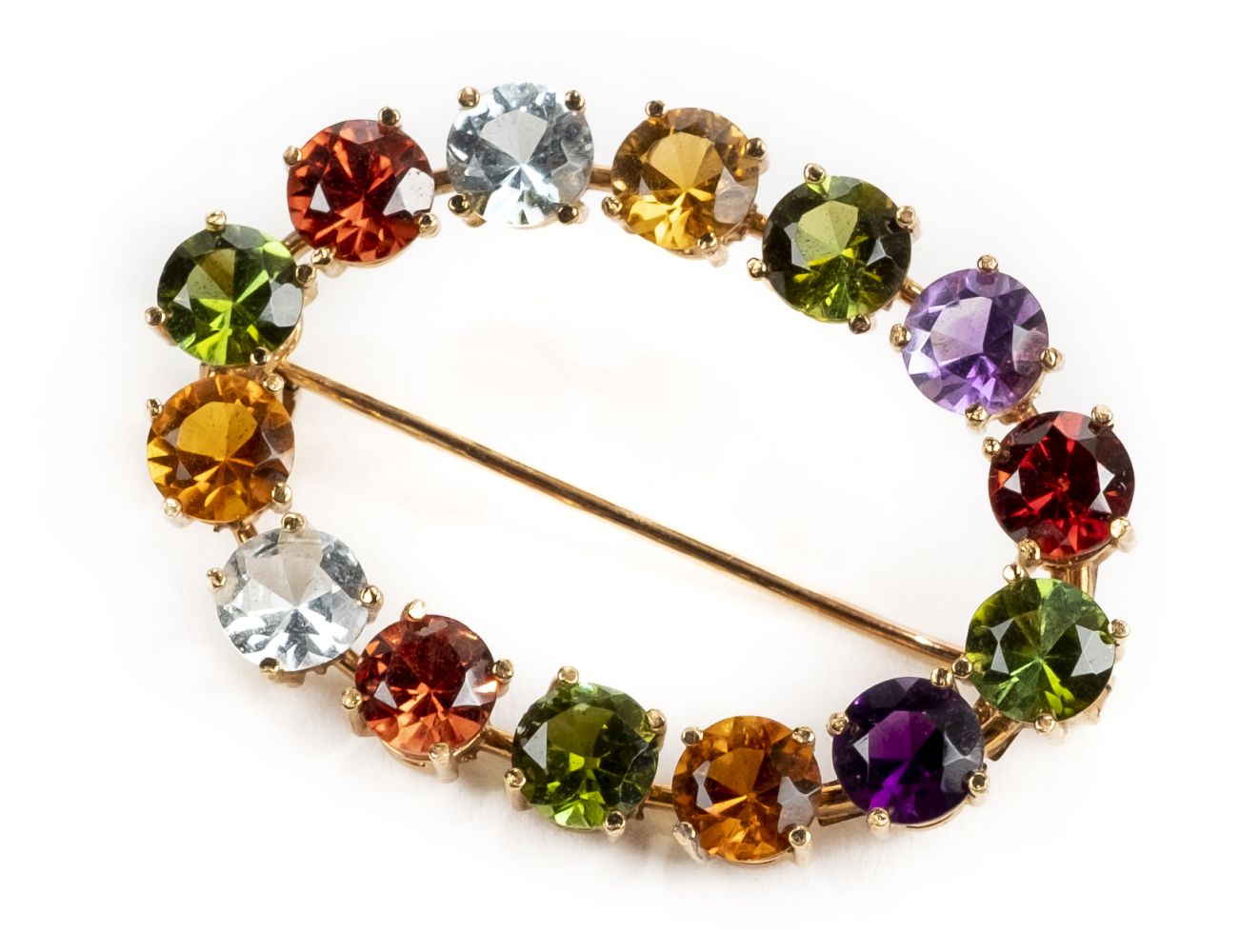 * Brooch. A Continental 18ct gold multigem set brooch