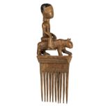 * Comb. An African carved wood comb