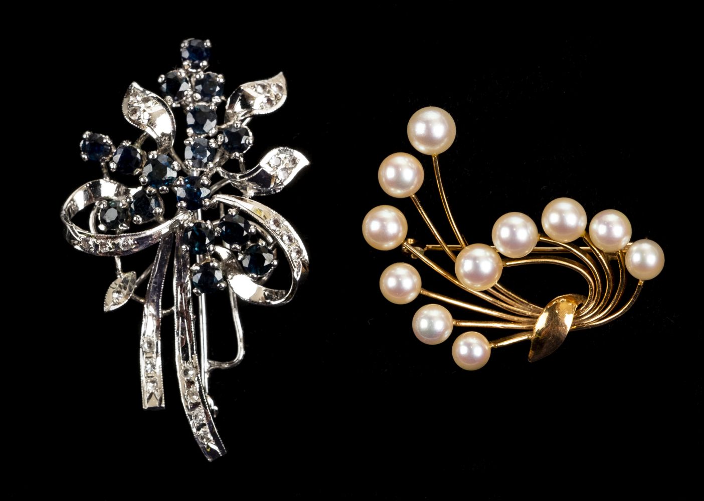 * Brooches. A white metal brooch set with diamonds and sapphires